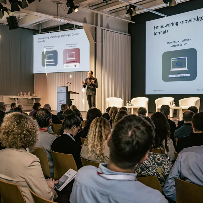 Bogdan Draganski on stage, with the audience seen from behind in the foreground